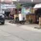 Salah satu warga saat mau melintas dijalan betonisasi yang dikerjakan oleh pemkab Sidoarjo.