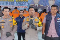 Kapolresta Sidoarjo Kombes. Pol. Christian Tobing didampingi anggota saat berikan keterangan didepan awak media.
