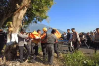 Petugas melakukan upaya evakuasi jasad korban. 
