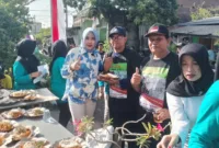 Hj Mimik Idayana bersama tim Warung Keliling gratis serta Rawon Bok Legi, bagikan makan dan minum ke masyarakat di Desa Punggul , Kec Gedangan, Jumat (2/8/2024).
