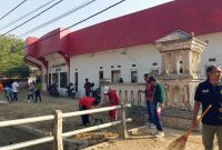 Sejumlah petugas terlihat menyapu, mengumpulkan sampah, dan membersihkan area sekitar saluran air.